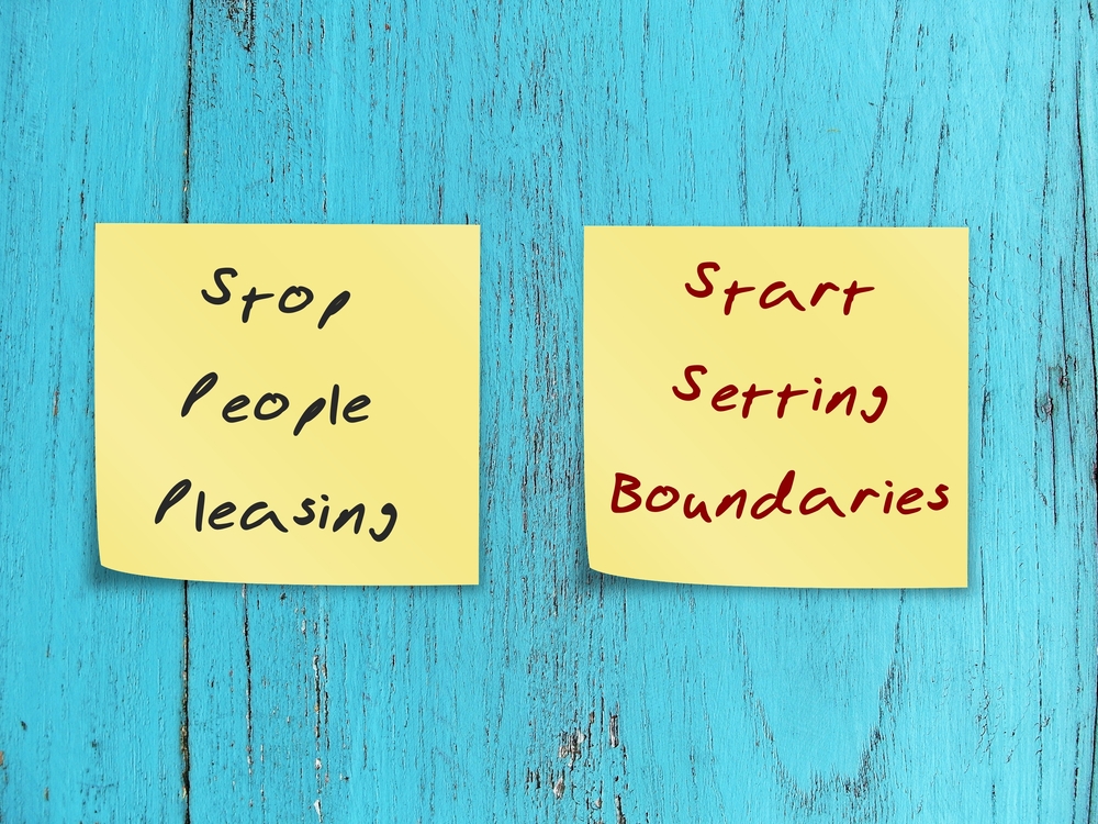 Sticky notes reading “Stop people pleasing” and “Start setting boundaries,” representing the shift toward healthier boundaries and self-trust.